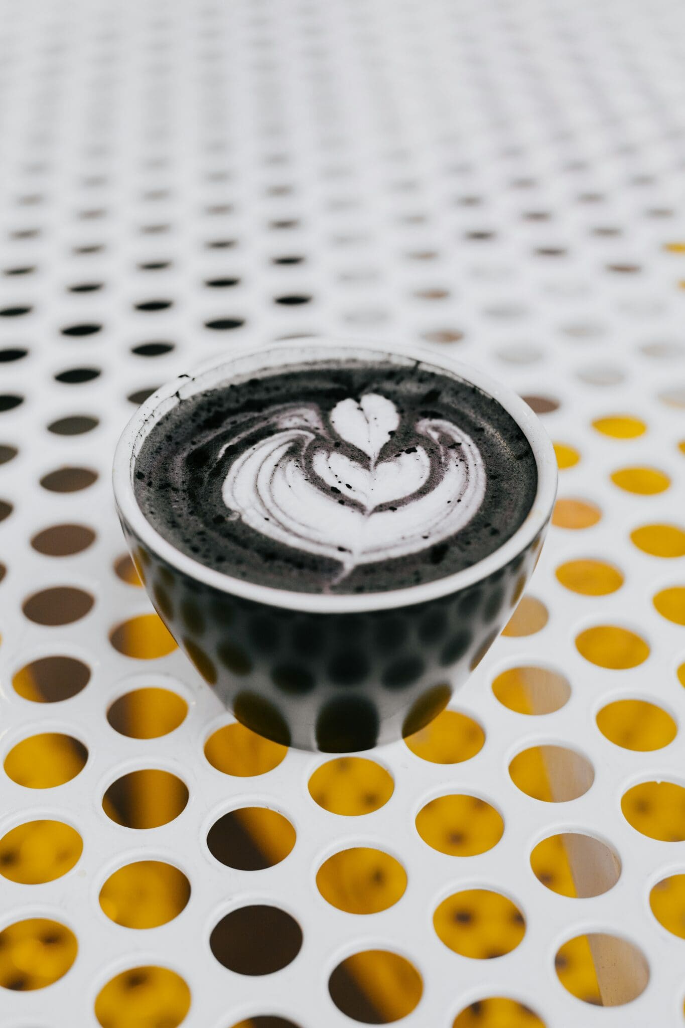 A cup of coffee with a heart design on it.