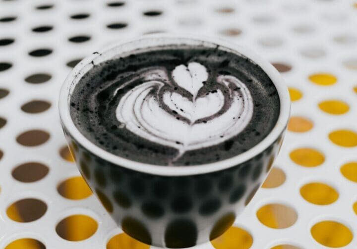 A cup of coffee with a heart design on it.